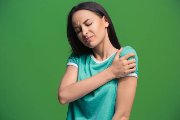Midlife woman holding her shoulder due to joint pain