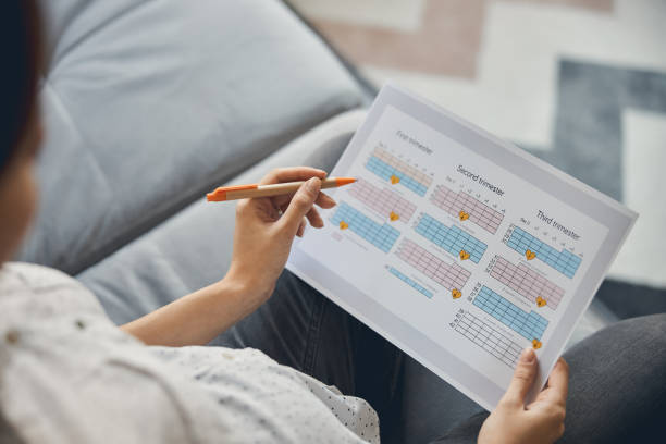Woman reviewing her cycle tracker after stopping birth control
