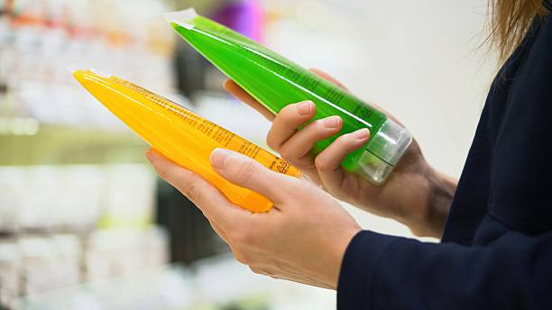 Woman checking beauty product ingredients