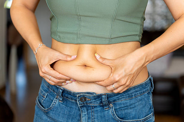 woman stressed and gaining belly fat despite eating healthy