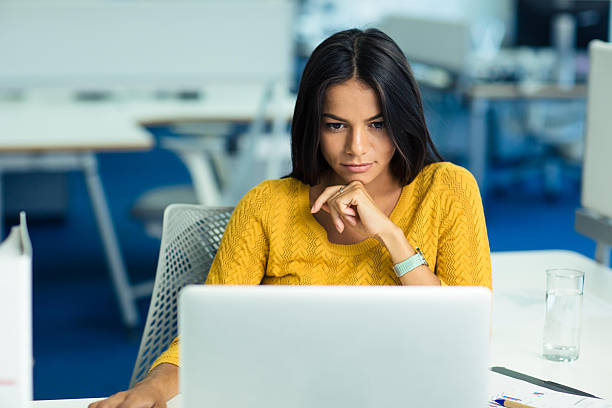 woman tired sitting at desk metabolism slowdown