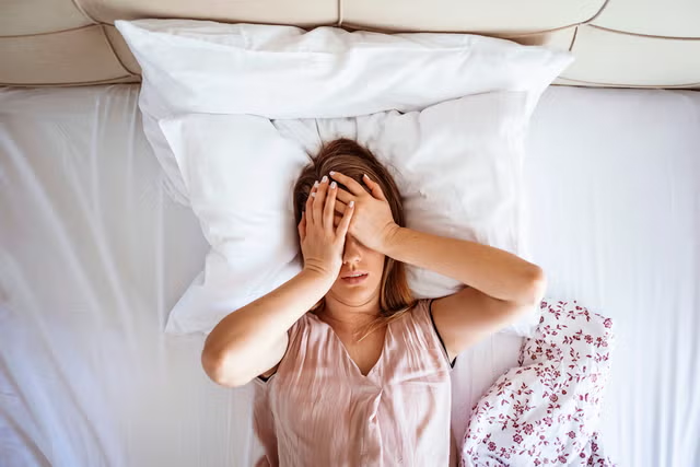 Woman awake at 3 AM during perimenopause insomnia