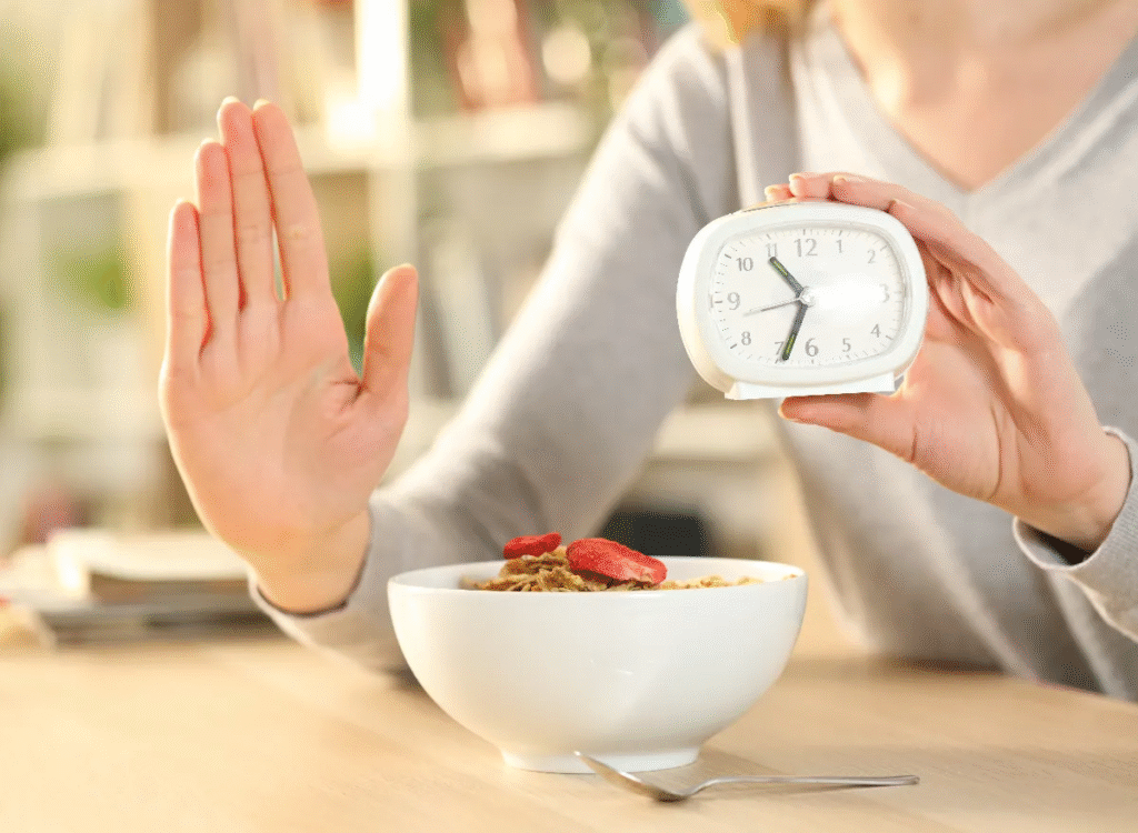 Woman practicing intermittent fasting with a clock